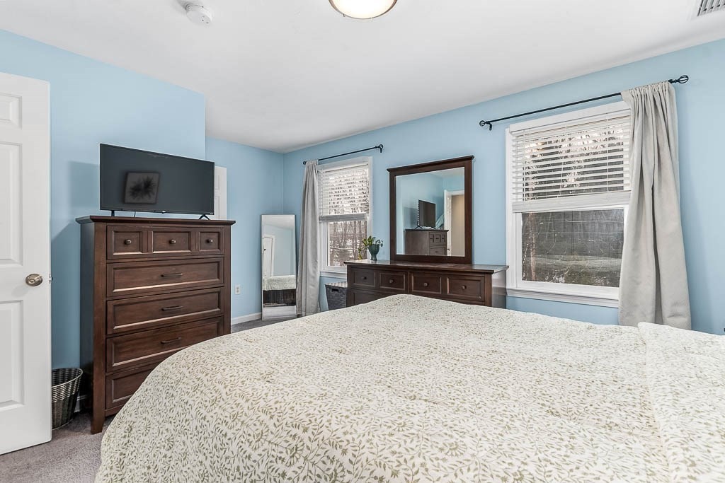 272 Union Street, Unit 272 Walpole, MA 02032 - Photo 16 of 27 a bedroom with a bed and a flat screen tv