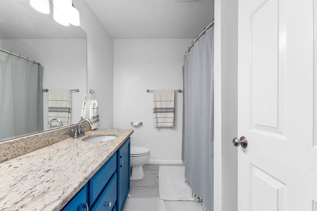 272 Union Street, Unit 272 Walpole, MA 02032 - Photo 20 of 27 a bathroom with a granite countertop sink toilet and shower