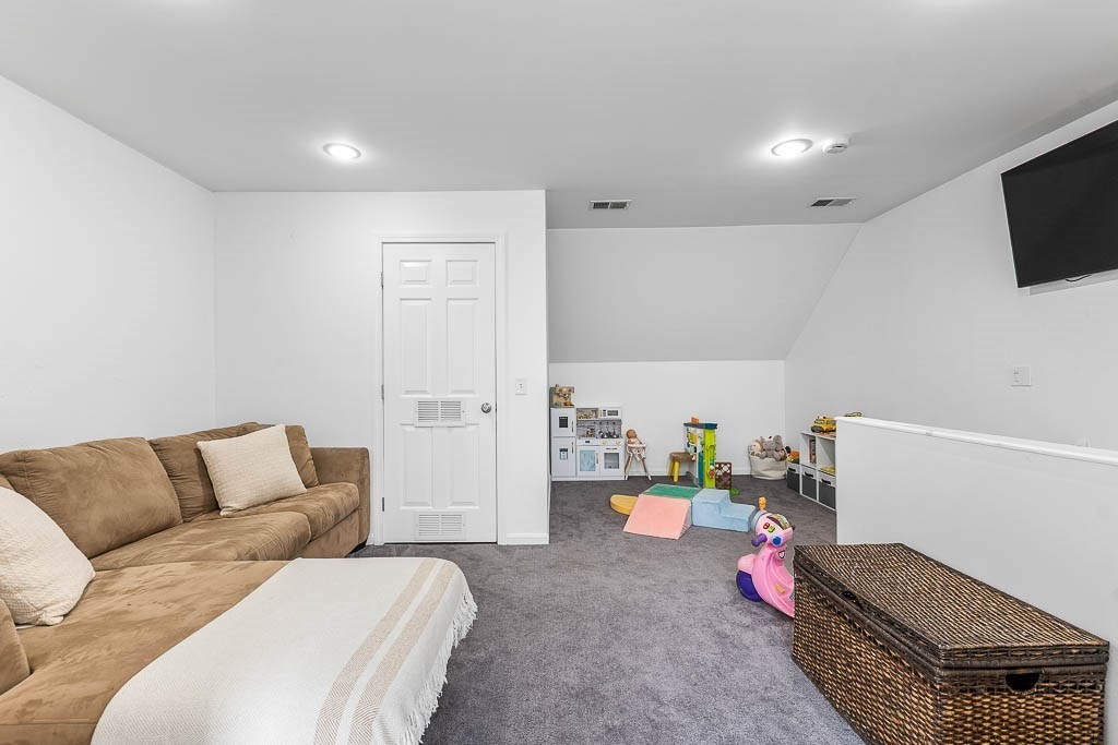 272 Union Street, Unit 272 Walpole, MA 02032 - Photo 21 of 27 a bedroom with furniture and a couch