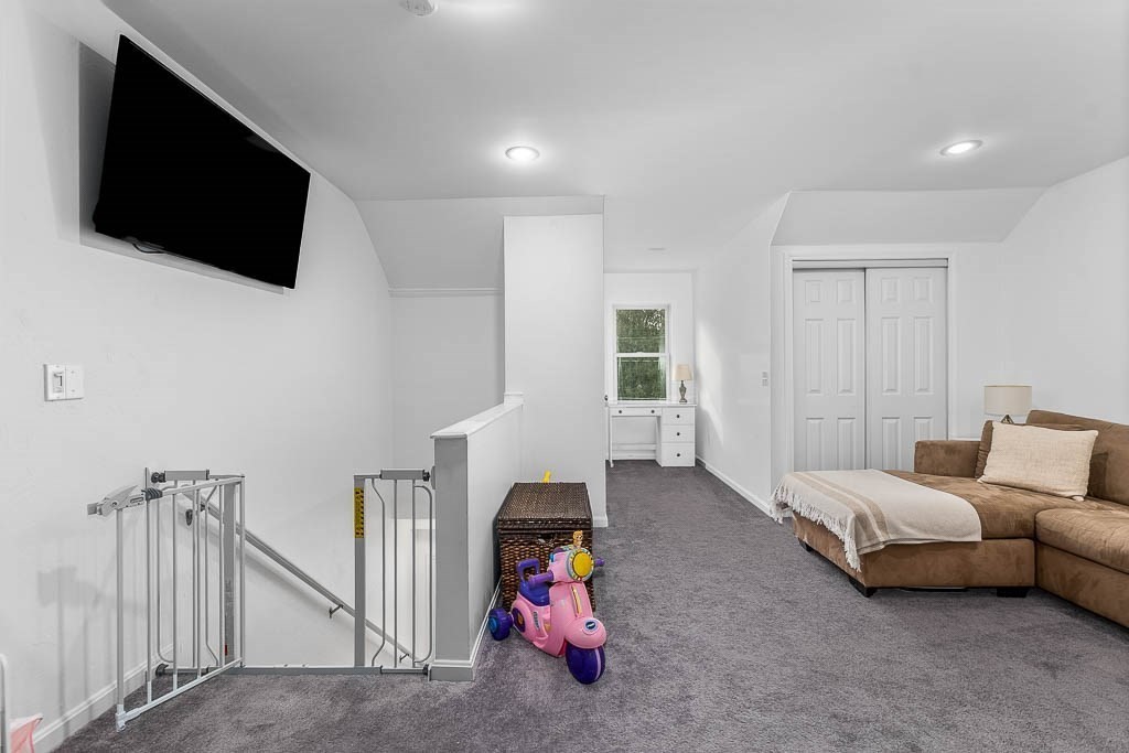 272 Union Street, Unit 272 Walpole, MA 02032 - Photo 22 of 27 a room with furniture and a flat screen tv