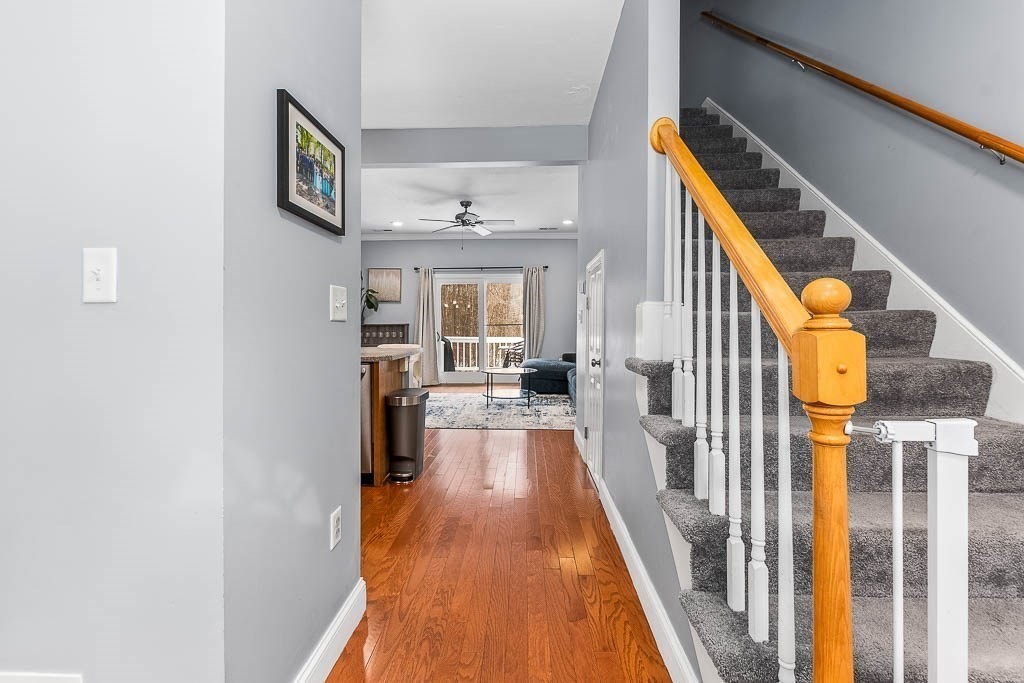 272 Union Street, Unit 272 Walpole, MA 02032 - Photo 3 of 27 a view of a hallway with wooden floor and staircase