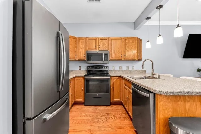 a kitchen with a sink appliances and cabinets