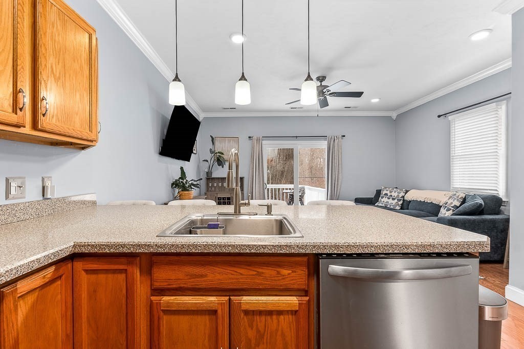 272 Union Street, Unit 272 Walpole, MA 02032 - Photo 6 of 27 a kitchen with granite countertop a sink a counter top space cabinets and stainless steel appliances