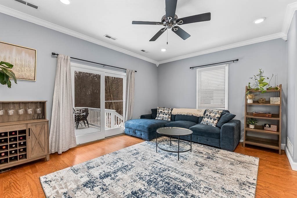 272 Union Street, Unit 272 Walpole, MA 02032 - Photo 9 of 27 a living room with furniture a rug and a chandelier