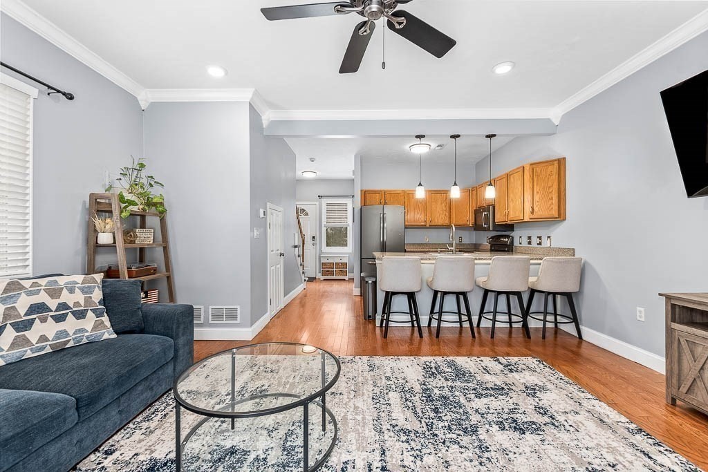 272 Union Street, Unit 272 Walpole, MA 02032 - Photo 10 of 27 a living room with furniture and a flat screen tv