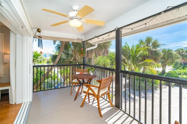 a view of a porch with furniture and a floor to ceiling window
