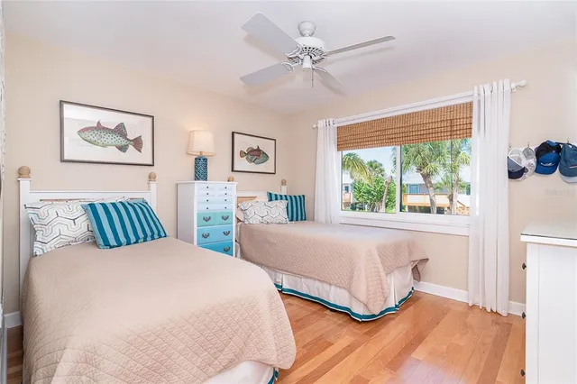 a bedroom with two beds and a large window