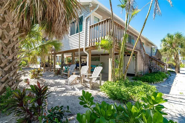a view of a chairs and table in a backyard