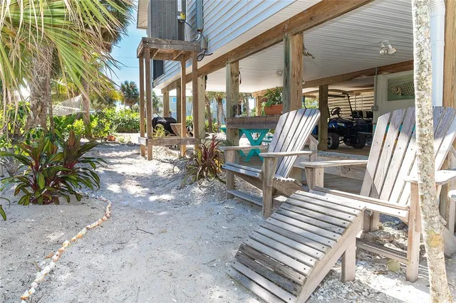 a view of a patio with table and chairs and potted plants