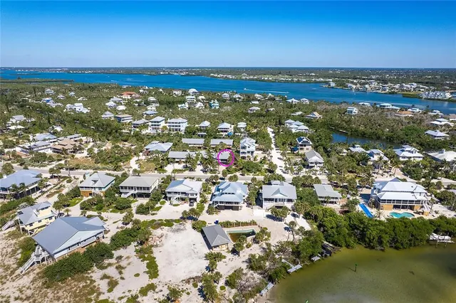 an aerial view of residential building with outdoor space and lake view