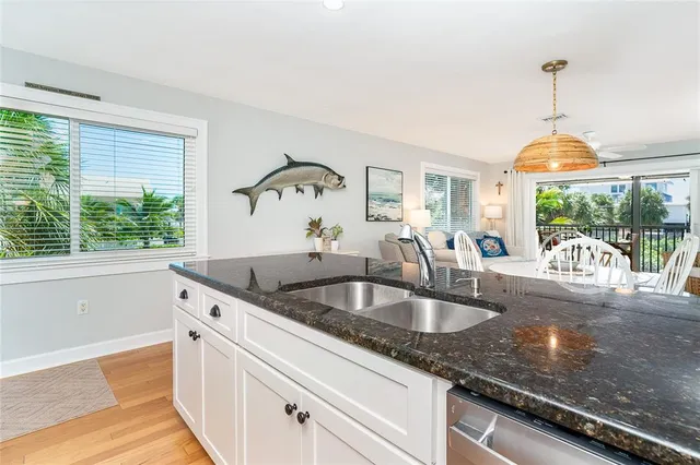 a kitchen with granite countertop a sink and a window