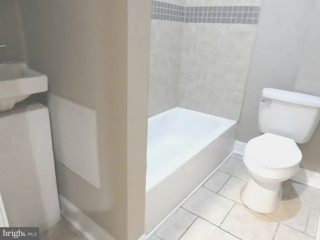 a white toilet sitting next to a white sink