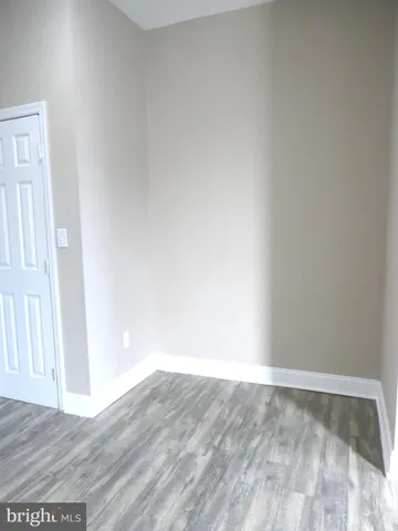 a view of an empty room and wooden floor