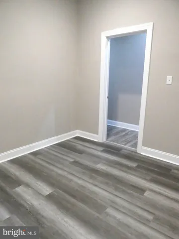 an empty room with wooden floor