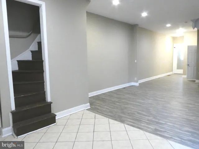 a view of an empty room and stairs