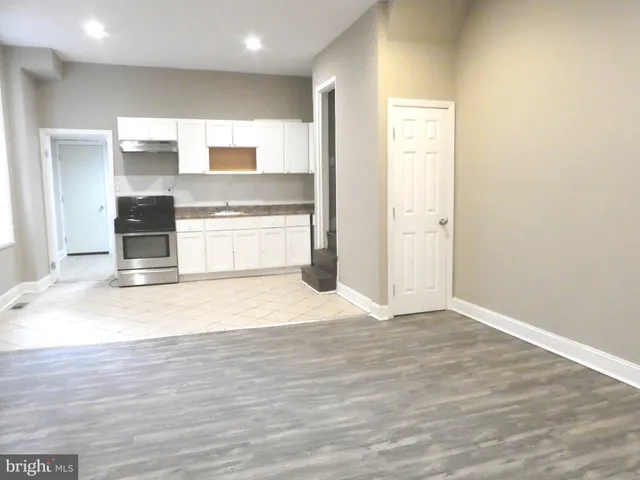 a view of a kitchen with a sink and a large window