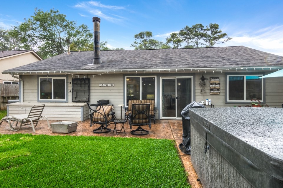 9211 Benwick Street Spring, TX 77379 - Photo 23 of 27 a house view with a sitting space and garden space