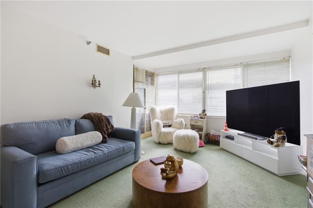 750 Washington Road, Unit 307 Pittsburgh, PA 15228 - Photo 7 of 24 a living room with furniture and a flat screen tv