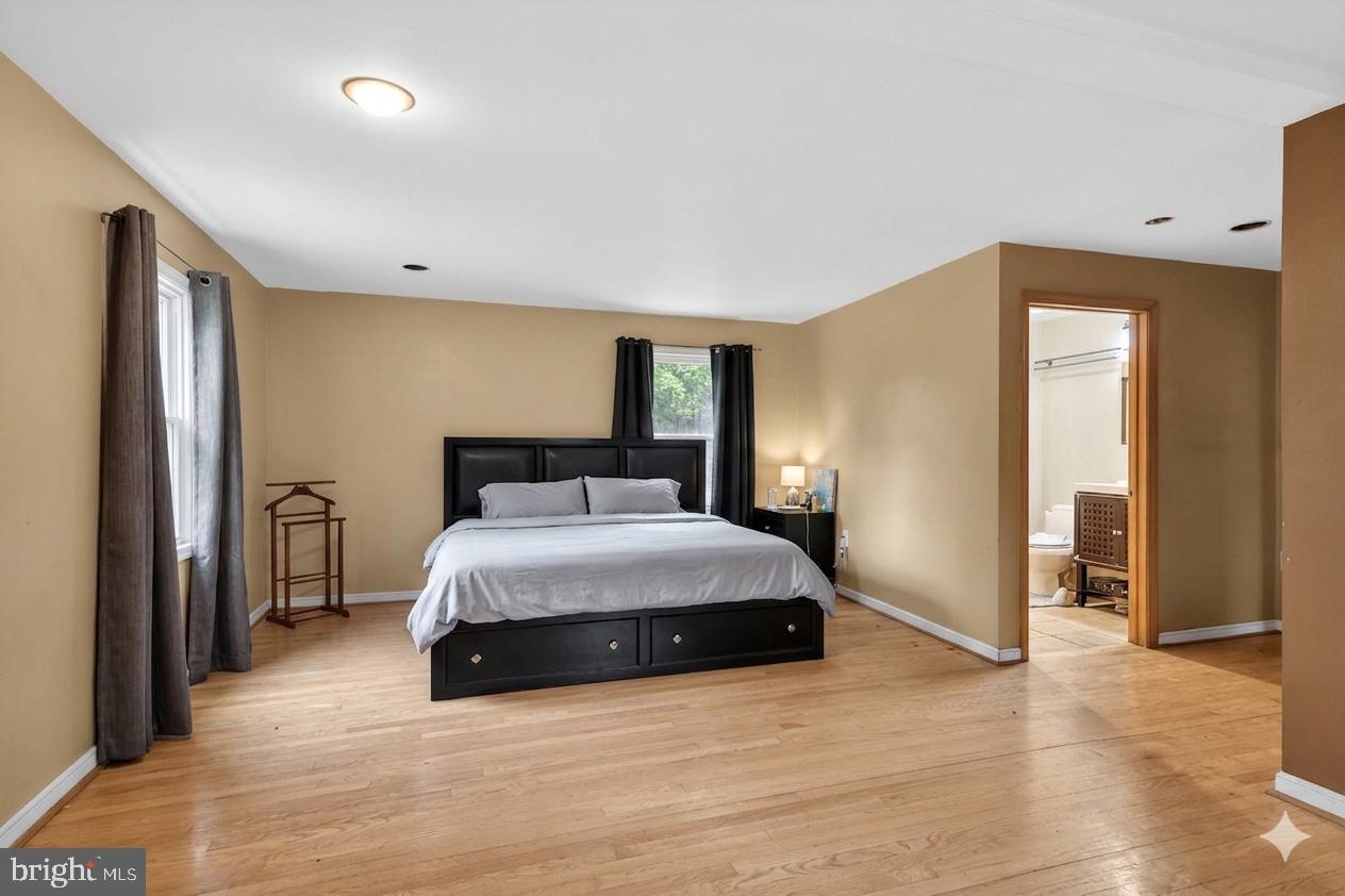 4516 Yates Road Beltsville, MD 20705 - Photo 12 of 31 a spacious bedroom with a bed and wooden floor