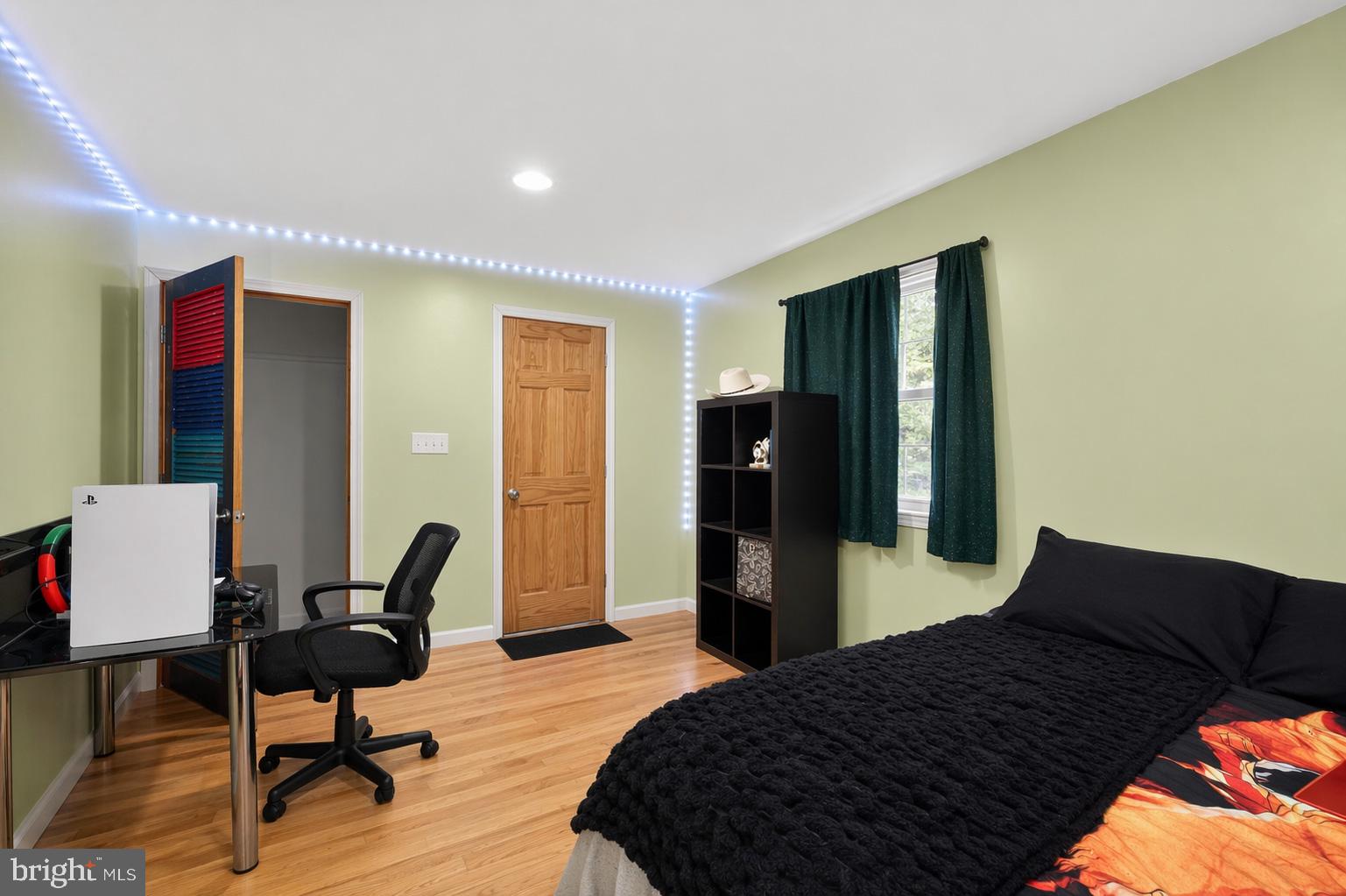 4516 Yates Road Beltsville, MD 20705 - Photo 16 of 31 a bedroom with a bed and wooden floor
