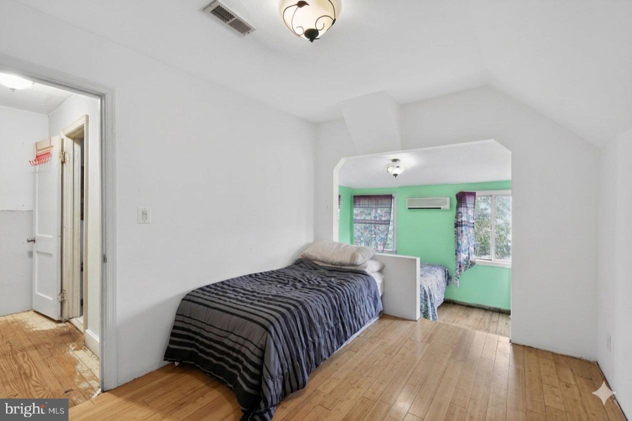 4516 Yates Road Beltsville, MD 20705 - Photo 18 of 31 a bedroom with a bed and wooden floor