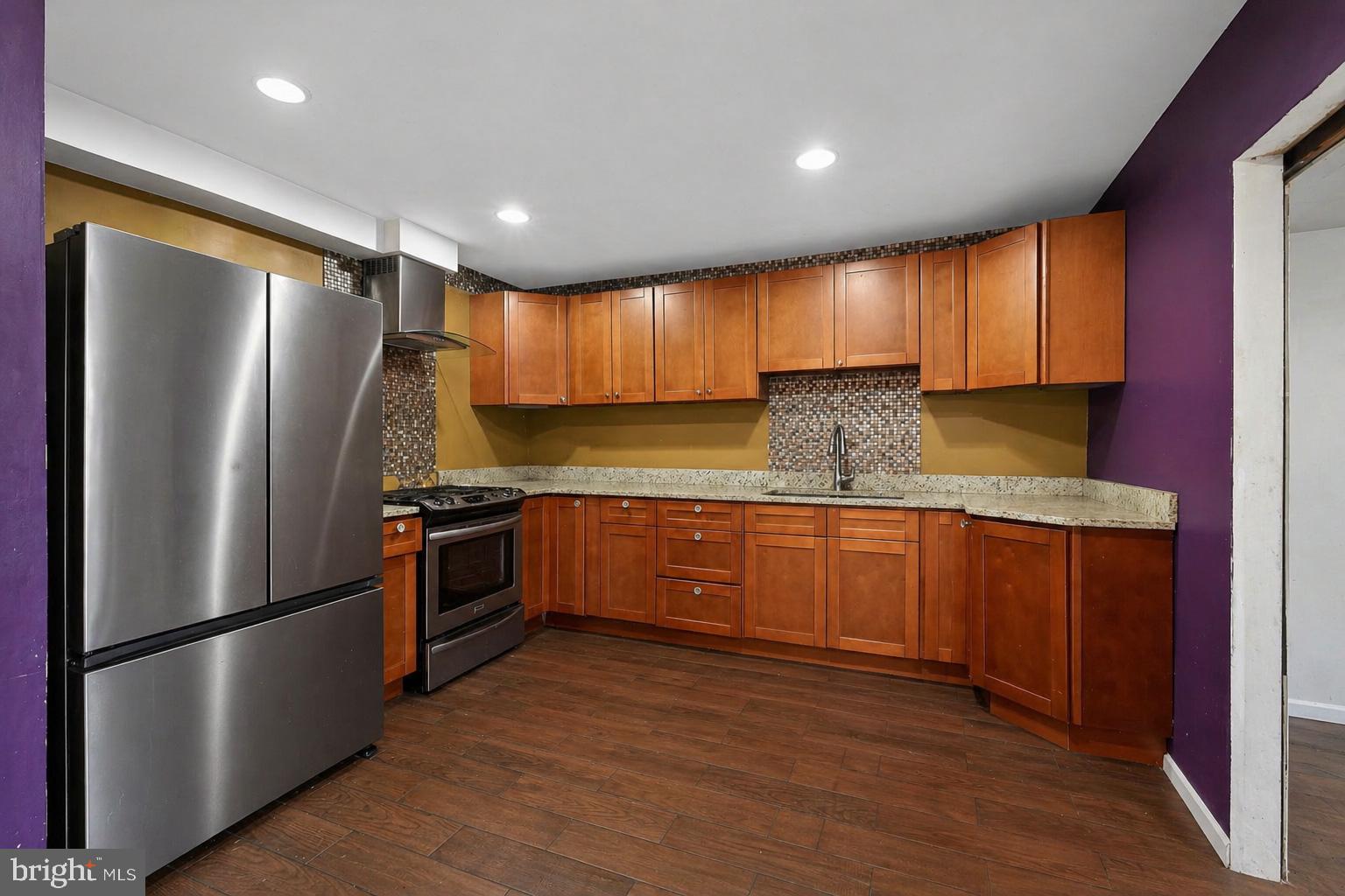 4516 Yates Road Beltsville, MD 20705 - Photo 3 of 31 a kitchen with granite countertop stainless steel appliances a refrigerator sink and cabinets