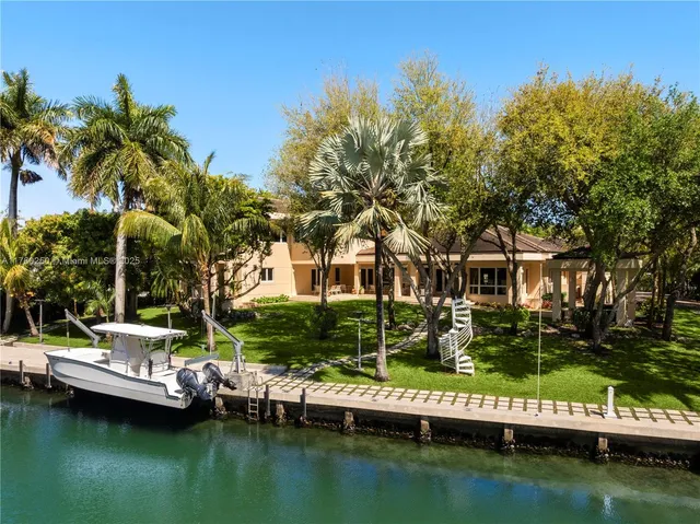 a view of house with swimming pool and green space
