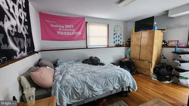 a bed sitting in a bedroom next to a window