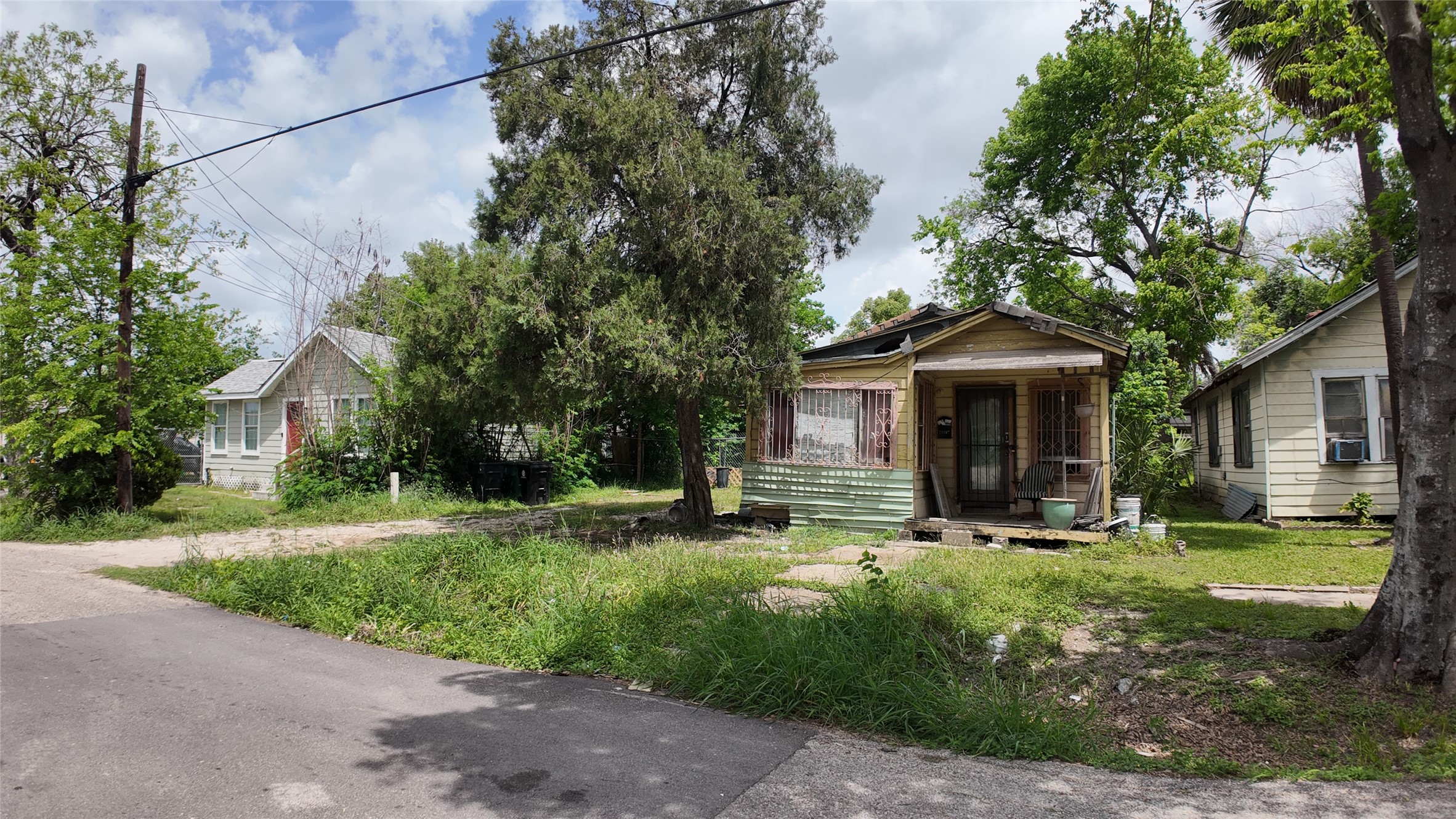 7935 Sherman Street Houston, TX 77012 - Photo 11 of 23 a front view of a house with yard and trees