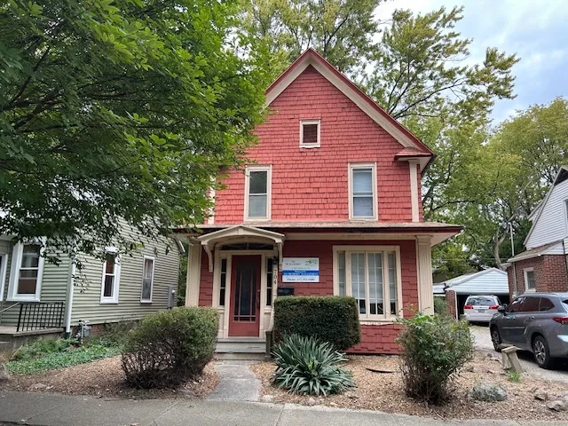 a front view of a house with garden and porch