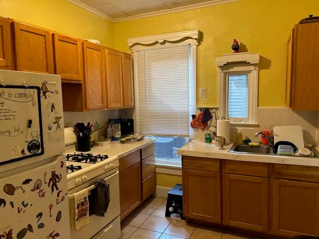 a kitchen with stainless steel appliances a sink stove and cabinets