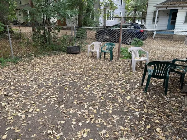 a view of backyard with seating space and trees