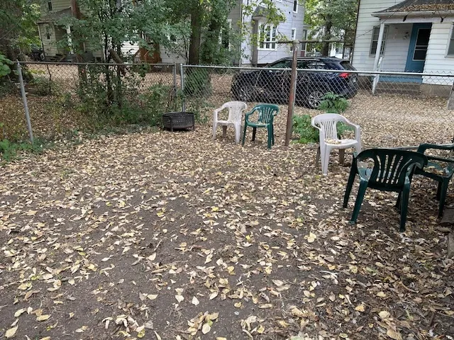a view of backyard with seating space and trees