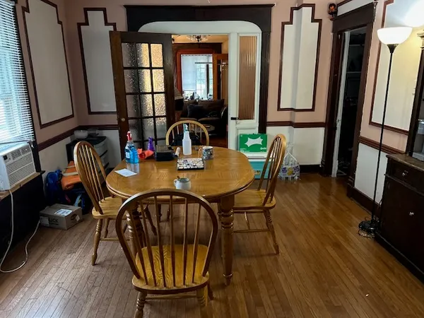 a view of a dining room with furniture and wooden floor