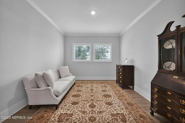 a dining room with furniture and wooden floor