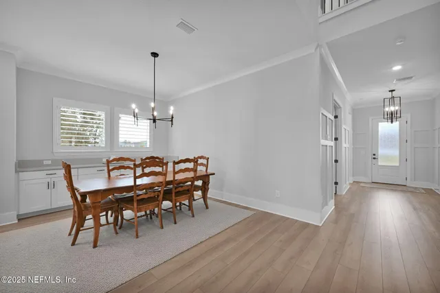 a large white kitchen with stainless steel appliances and white cabinets