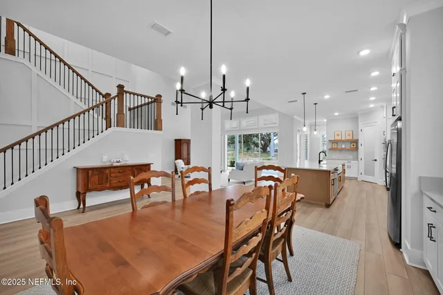 a kitchen with granite countertop a sink a counter space appliances and cabinets