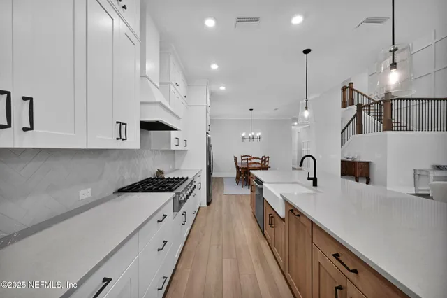 a bathroom with a double vanity sink mirror and shower