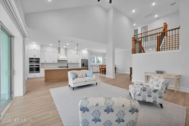 a view of a white house with a yard and plants