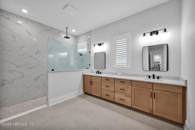 an aerial view of residential houses with outdoor space and trees