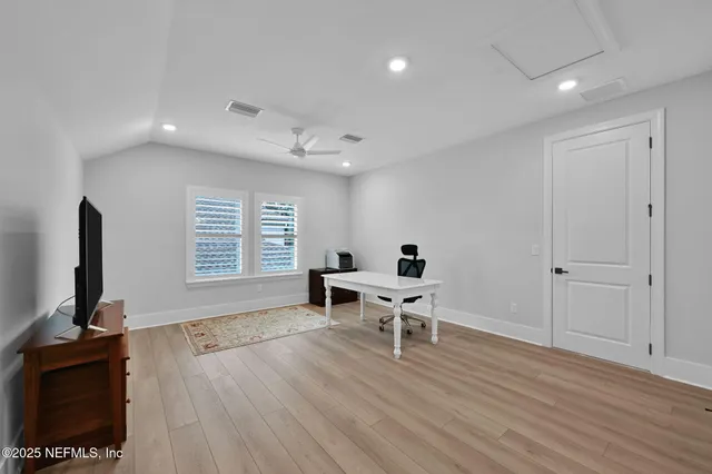 a aerial view of a house with a yard and large tree