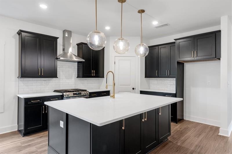 133 Old Alabama Road Southeast Emerson, GA 30137 - Photo 13 of 44 a kitchen with a kitchen island wooden floor and stainless steel appliances