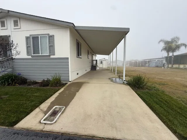 a view of a backyard with plants and lake view
