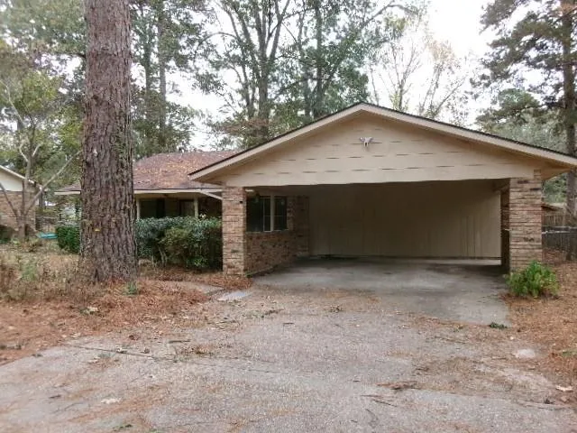 a view of house with a yard and garage