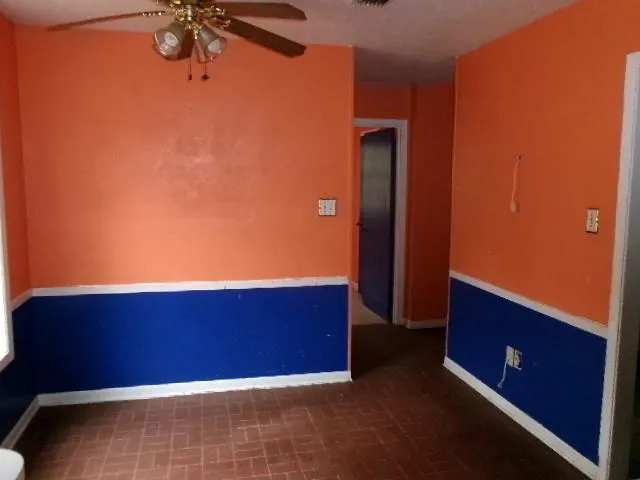 a view of an empty room and a window