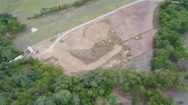 a view of a swimming pool with lawn chairs and plants