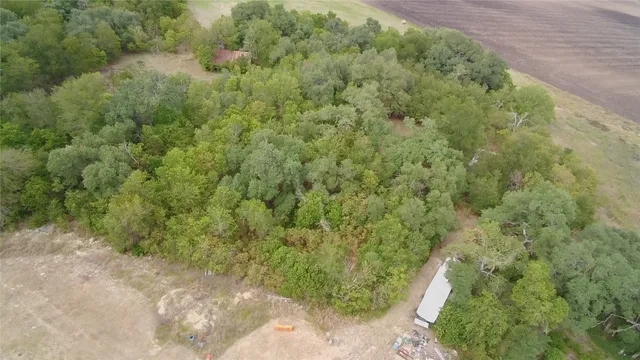 an aerial view of a house with a yard and lake view