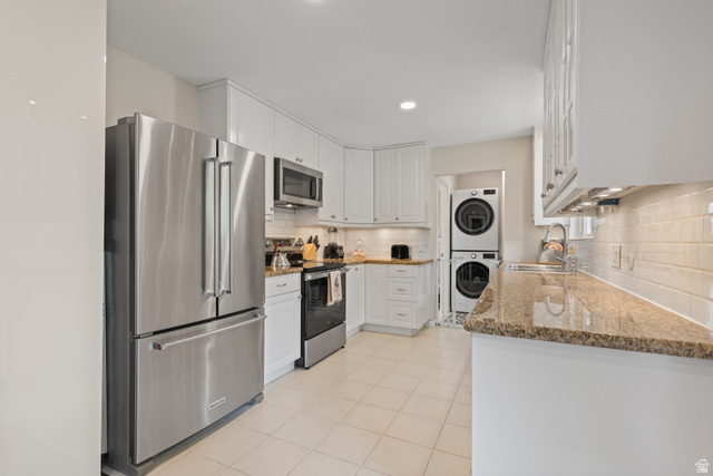 3320 Cherokee Lane Provo, UT 84604 - Photo 12 of 52 Bright kitchen featuring white cabinetry and light-toned tile flooring