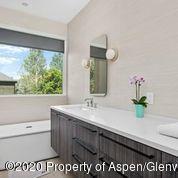 336 Allison Lane, Unit A Basalt, CO 81621 - Photo 12 of 18 a bathroom with a sink a mirror and a window