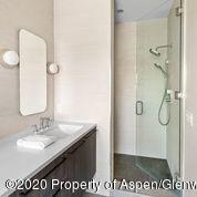 336 Allison Lane, Unit A Basalt, CO 81621 - Photo 14 of 18 a bathroom with a sink a mirror and a shower